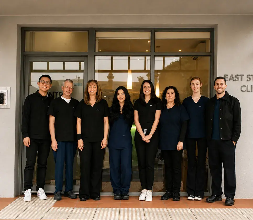 The East St Kilda Dental team standing together outside the clinic entrance
